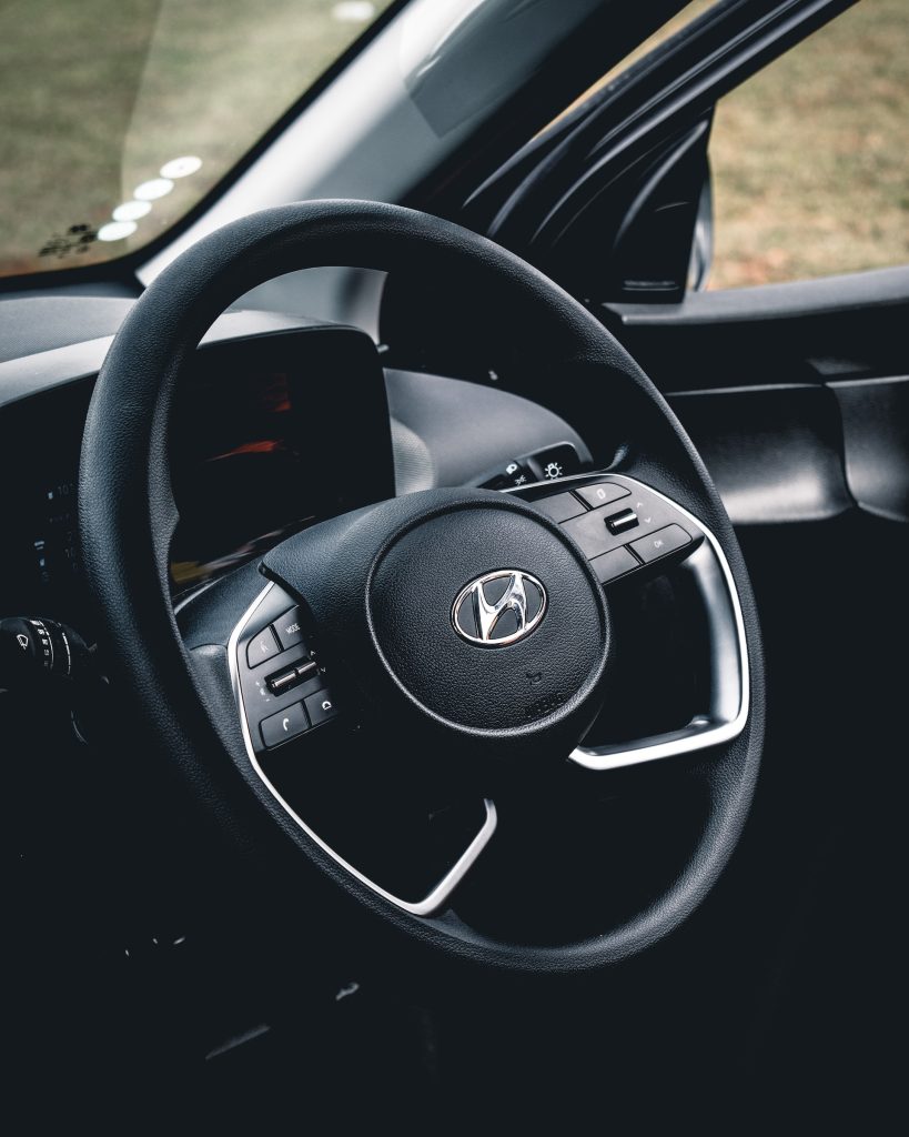A black steering wheel to a Hyundai car