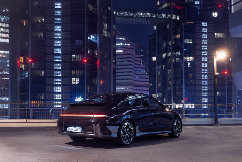 An INOIQ 6 model in front of a dark skyline