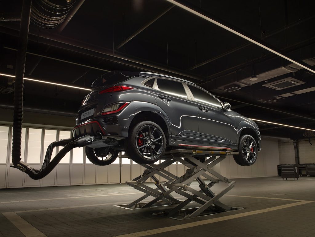 A Hyundai EV lifted up at the service shop to make sure the car is running properly