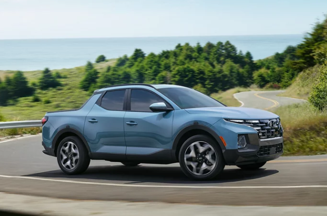 2024 Hyundai Santa Cruz in blue paint driving on a sunny Dublin, California day.