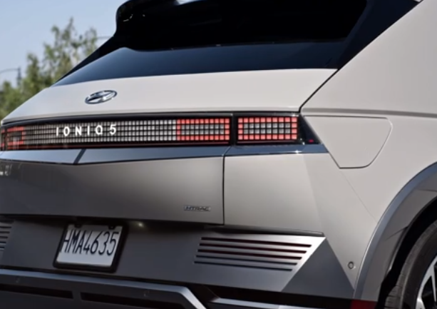 2024 Hyundai Ioniq 5 trunk exterior rear of vehicle charging port with white paint color.