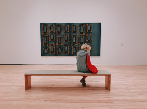 Woman sitting on bench in San Ramon Valley Museum near Dublin, CA.
