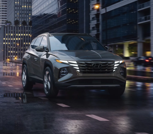 2024 Hyundai Tucson driving through a  city at night near Dublin, CA.