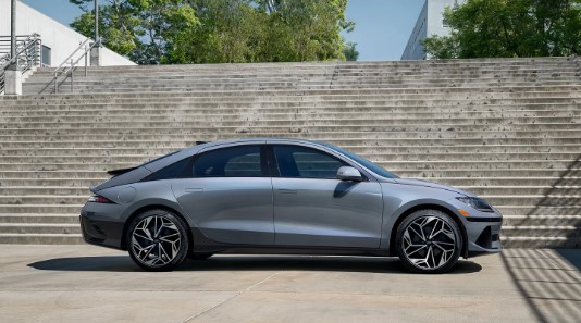 2024 Ioniq 6 in grey paint parked at the bottom of a staircase.