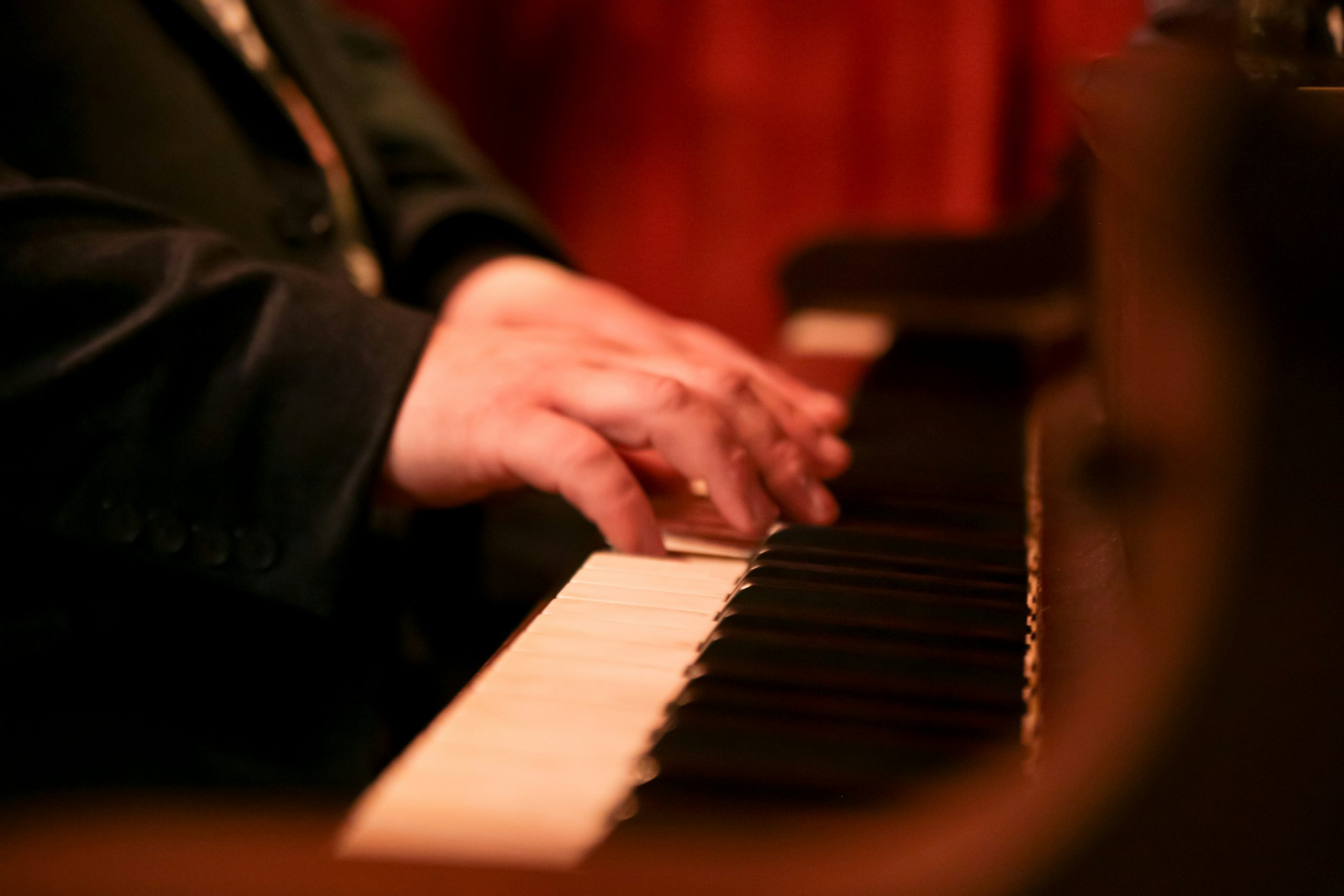 Closeup shot of a mans hand playing a piano in Dublin, CA.