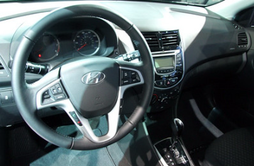 Hyundai steering wheel and dashboard close up photo.