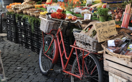 Bike parked in front of a vegetable stand at a Pleasanton, CA farmers market.