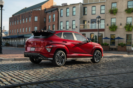 Red Hyundai Kona parked on a cobblestone street.